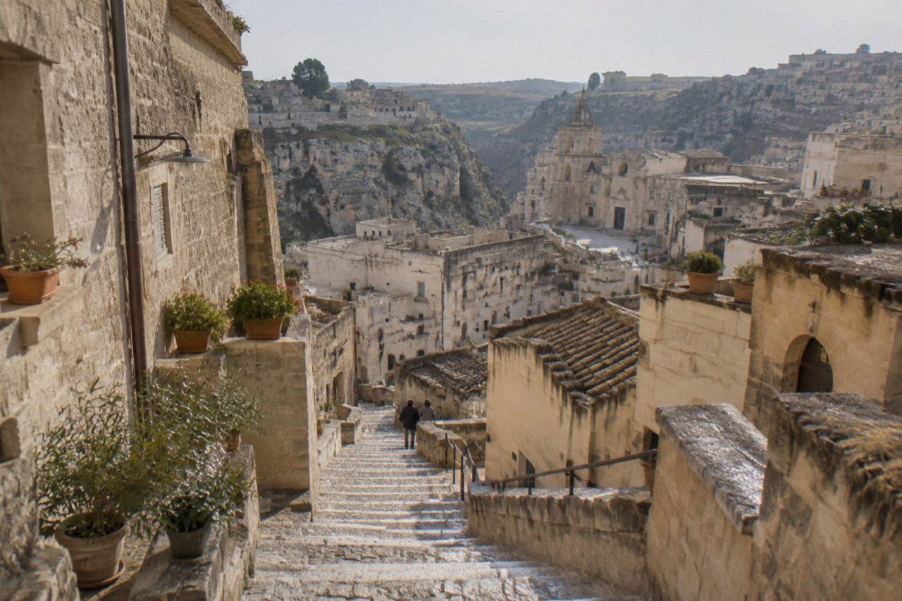 Stone stairway descending between pale cave houses in the Sassi districts of Matera