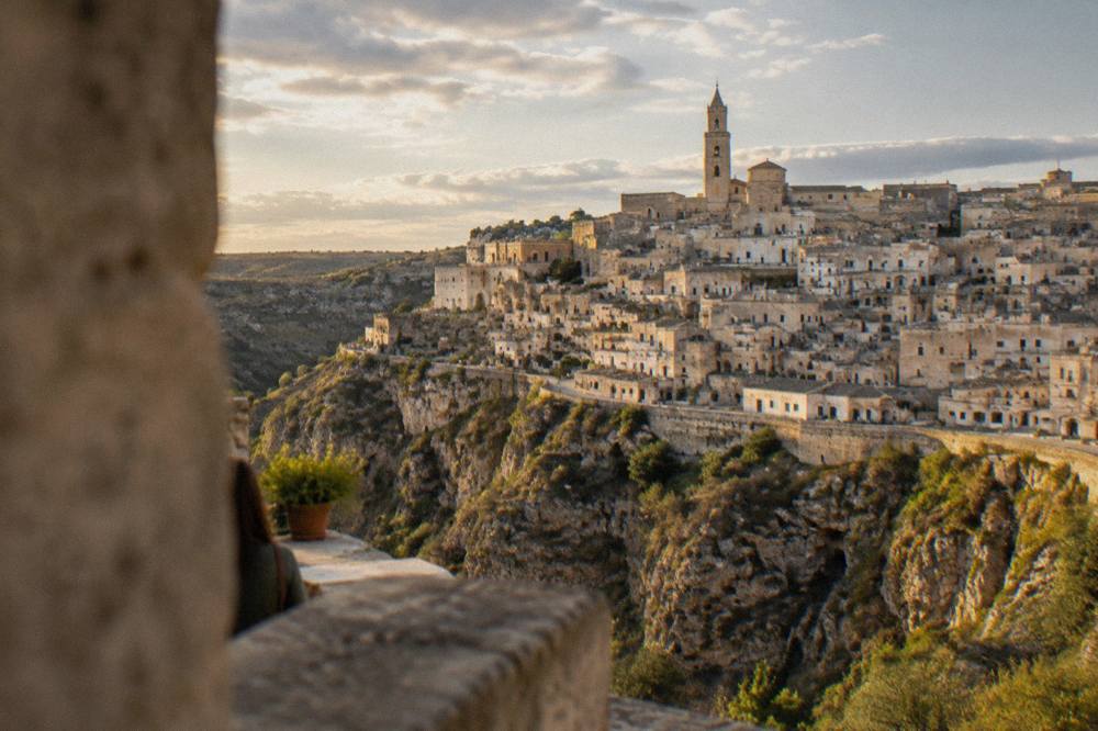 The Sassi of Matera seen from across the Gravina canyon at golden hour