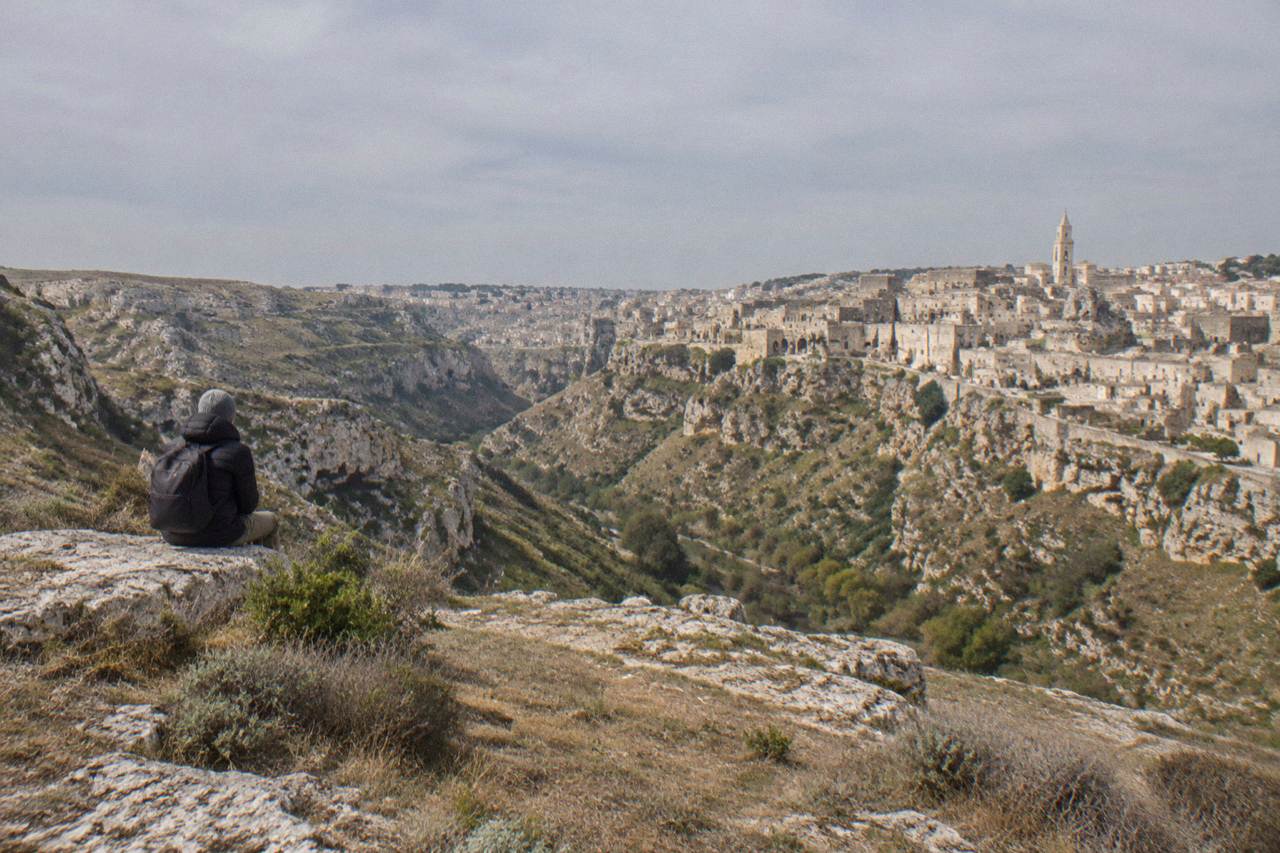 Cave houses and stone rooftops of the Sassi districts rising from the Gravina canyon in Matera