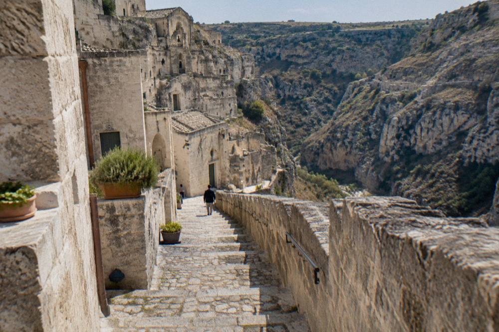 Stone stairway between pale tufa buildings in the Sasso Caveoso district of Matera