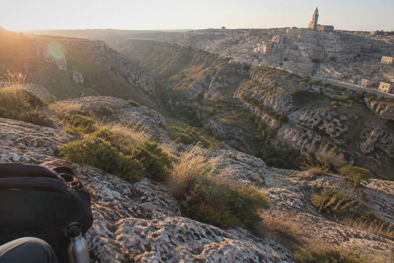 Pale stone cave dwellings of the Sassi districts rising above the Gravina canyon at Matera