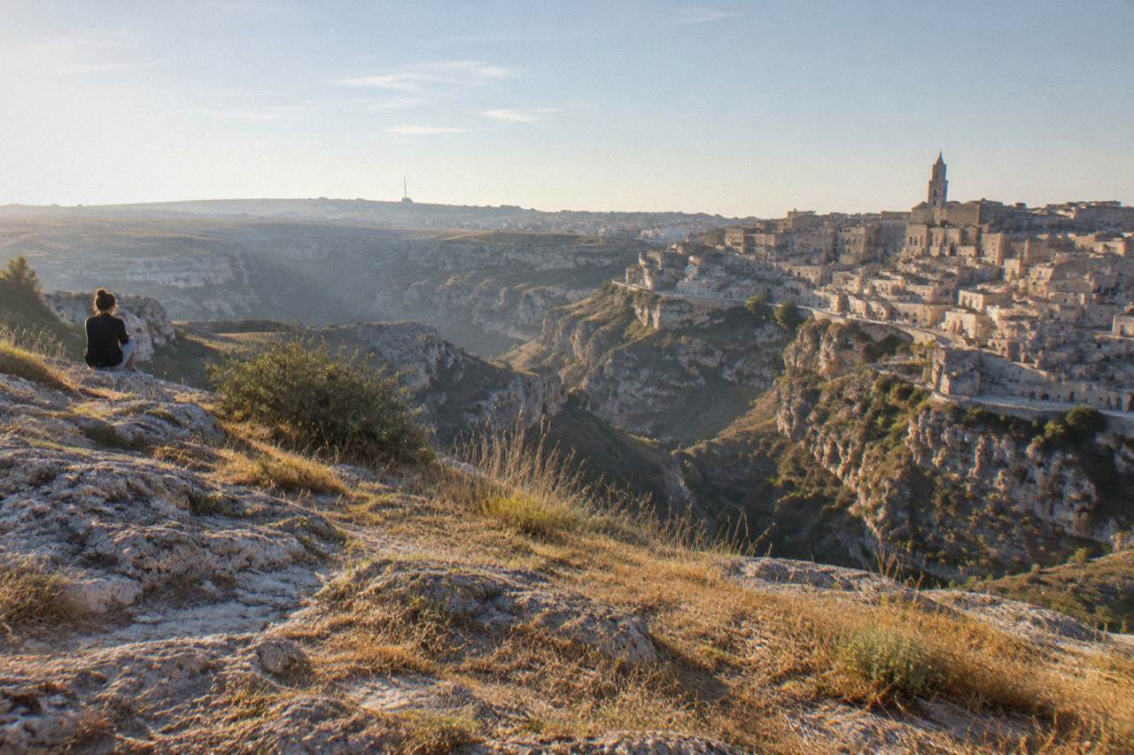 Stone cave houses and stairways of the Sassi districts in Matera seen across the Gravina canyon
