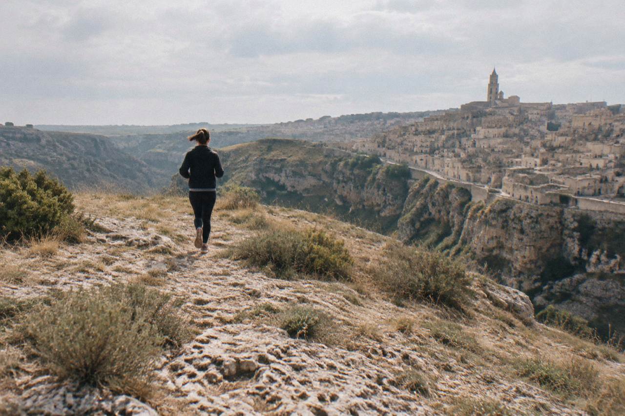 Cave dwellings and stone houses of the Sassi districts stacked along the edge of the Gravina canyon in Matera