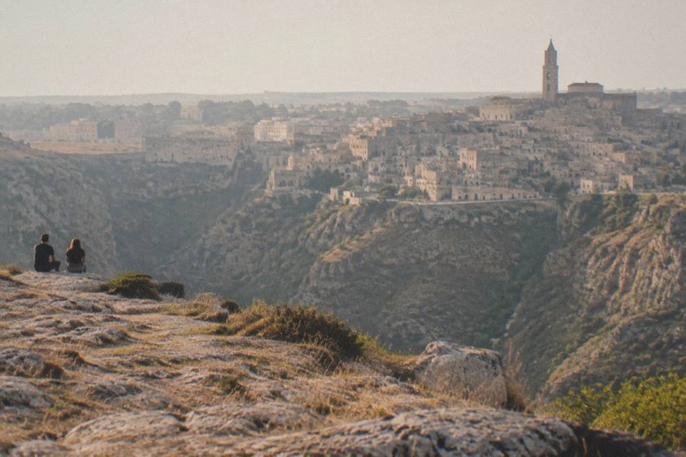 Evening view across the Gravina canyon toward the cave houses and rock churches of the Sassi at dusk