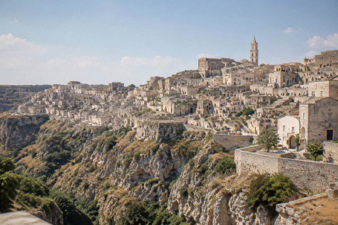 The pale stone rooftops of Matera seen from across the Gravina canyon