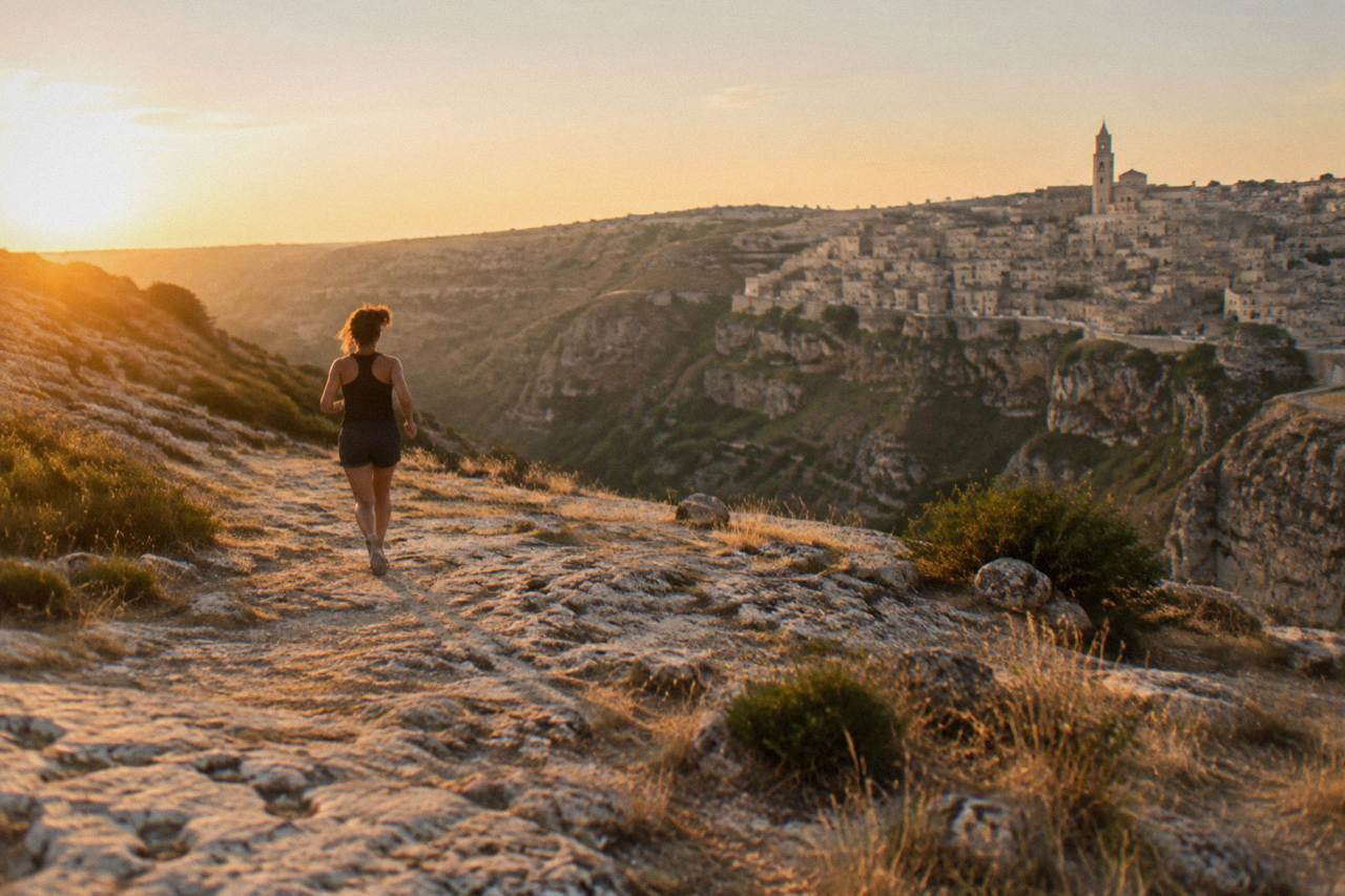 Cave dwellings and stone houses stacked along the edge of the Gravina canyon in Matera