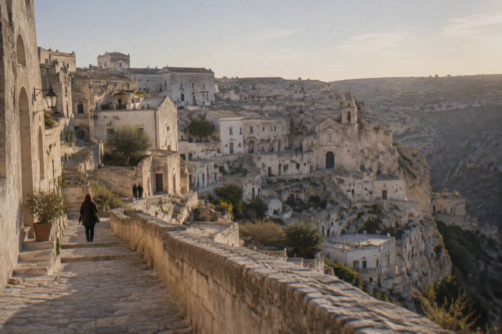 Restored stone buildings and cave facades in the Sassi of Matera at dusk