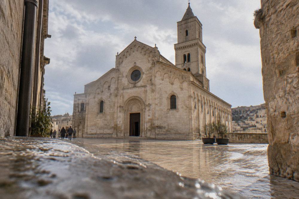 The apulian-romanesque facade of Matera Cathedral seen from a narrow lane