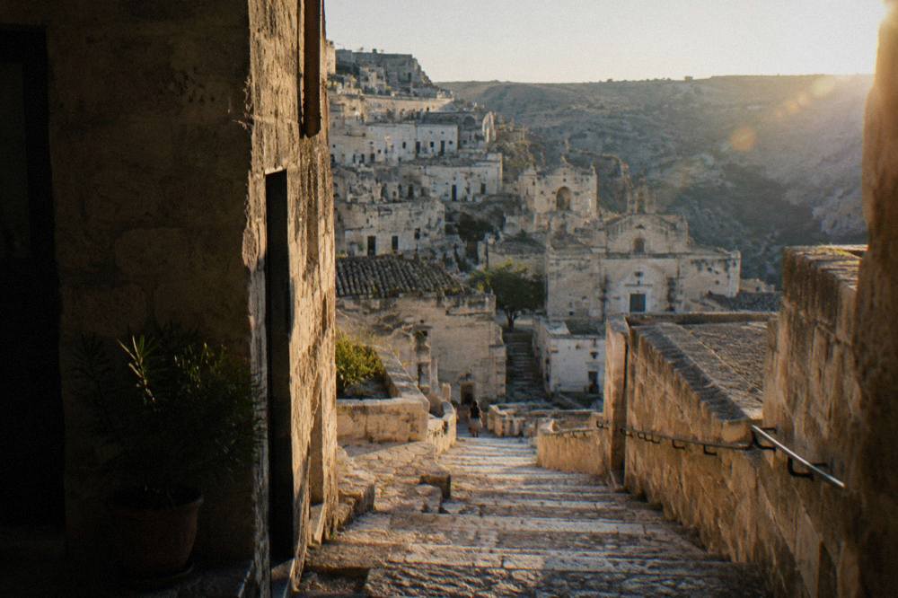 Stairway of worn stone steps connecting two levels of the Sassi in Matera