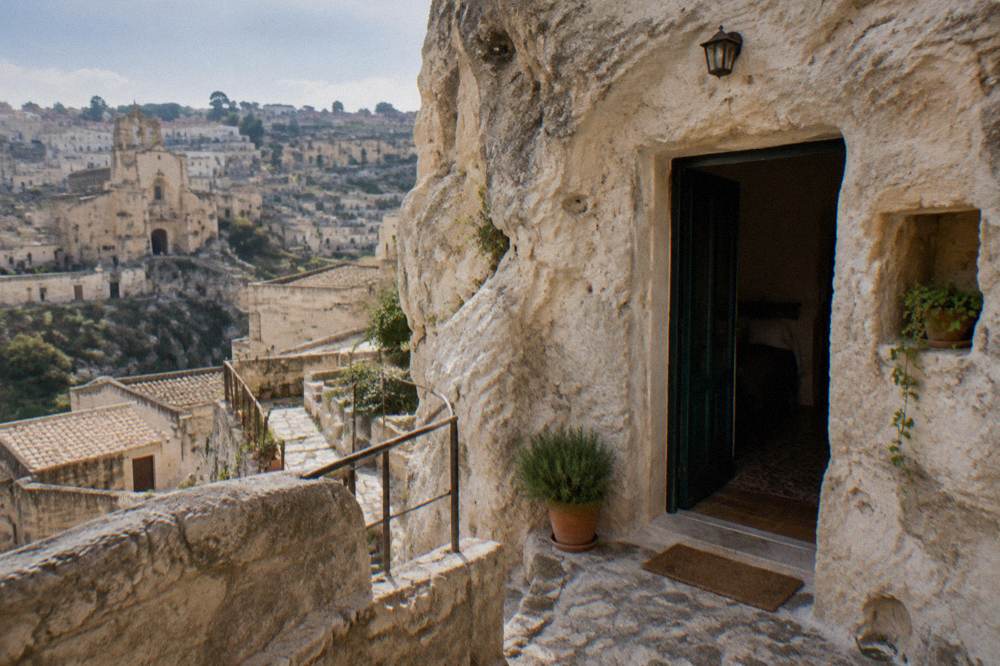 The exterior doorway of a cave house cut into the tufa rock in Matera