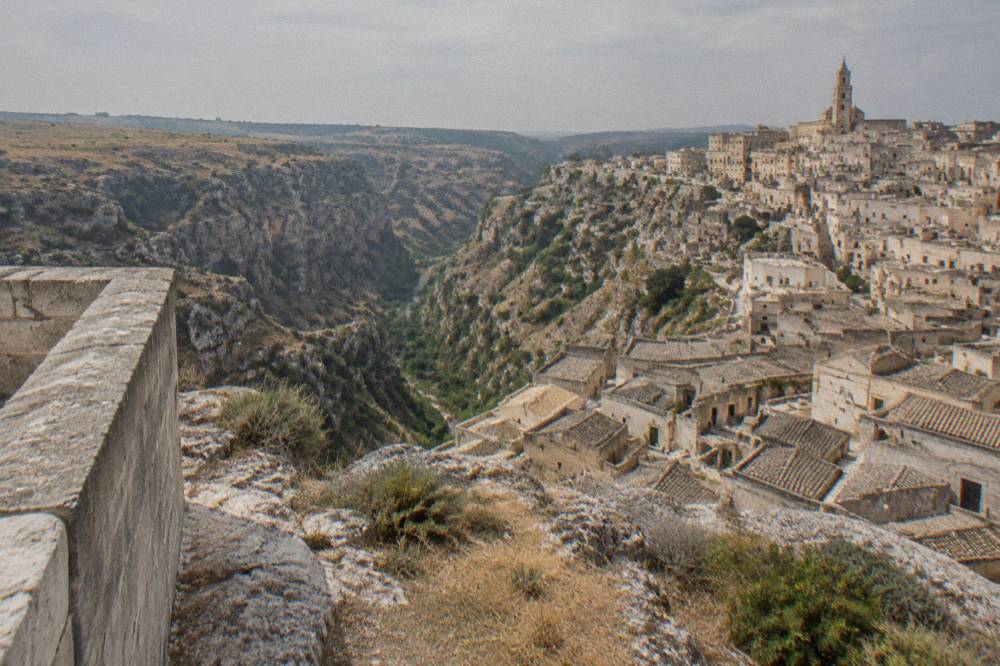 A view over the Sasso Caveoso rooftops and the Gravina canyon from a stone terrace