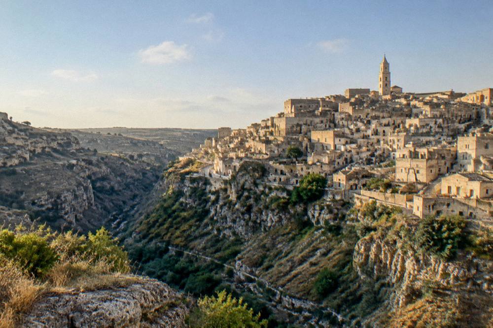 The Sassi district of Matera seen from the opposite side of the Gravina canyon in warm evening light
