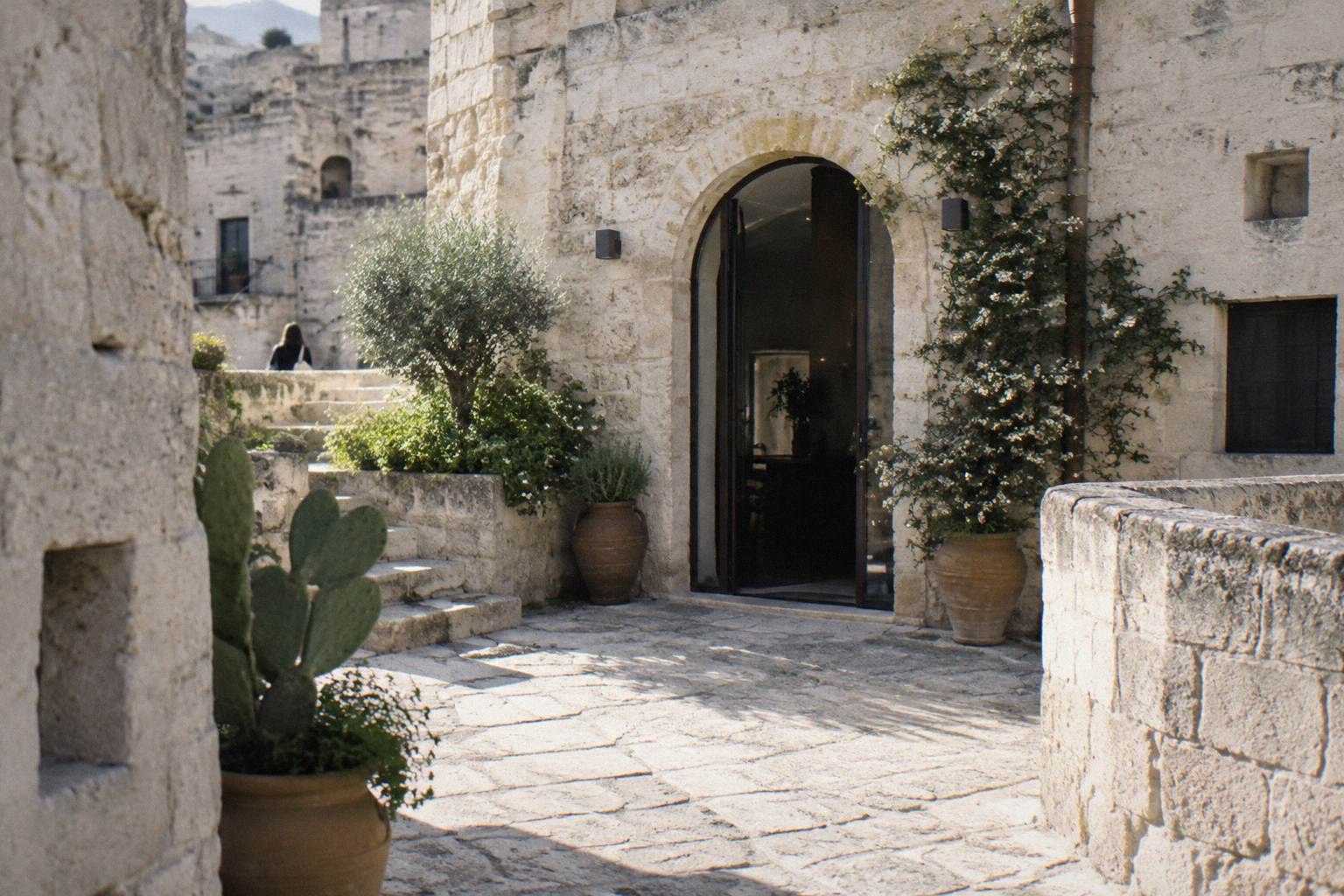 Whitewashed stone courtyard entrance in the Sasso Barisano on a quiet street