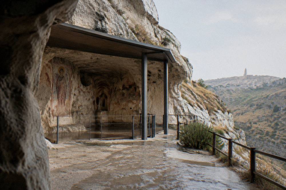 Frescoed rock wall with faded medieval painting inside a cave church