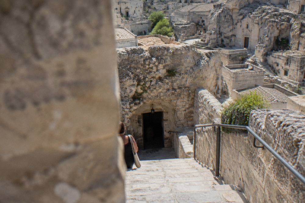 Stone staircase descending into a rock-cut cellar in the Sassi