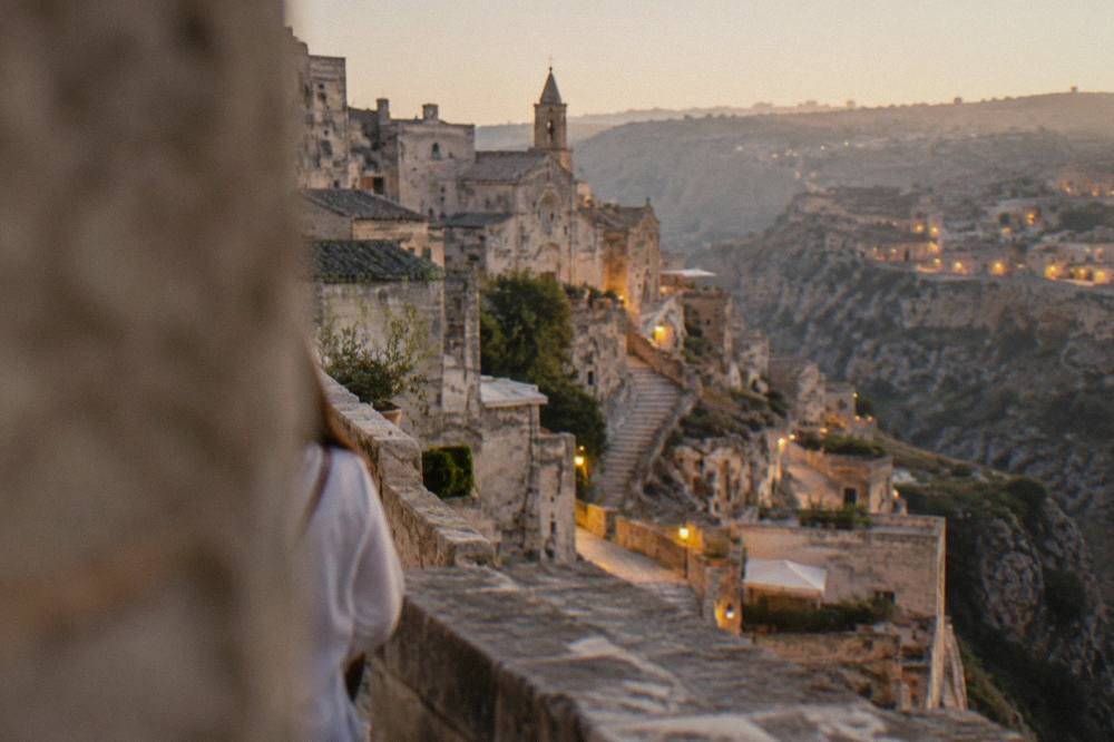 Matera Sassi at dusk with warm lights along the canyon