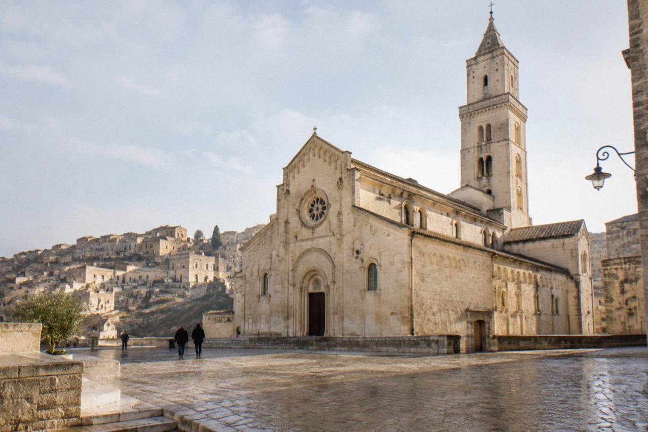 The Romanesque facade and bell tower of Matera Cathedral seen from the square in front of it