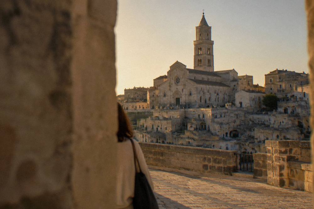 The bell tower of Matera Cathedral rising above the rooftops and cave dwellings of the Sasso Barisano