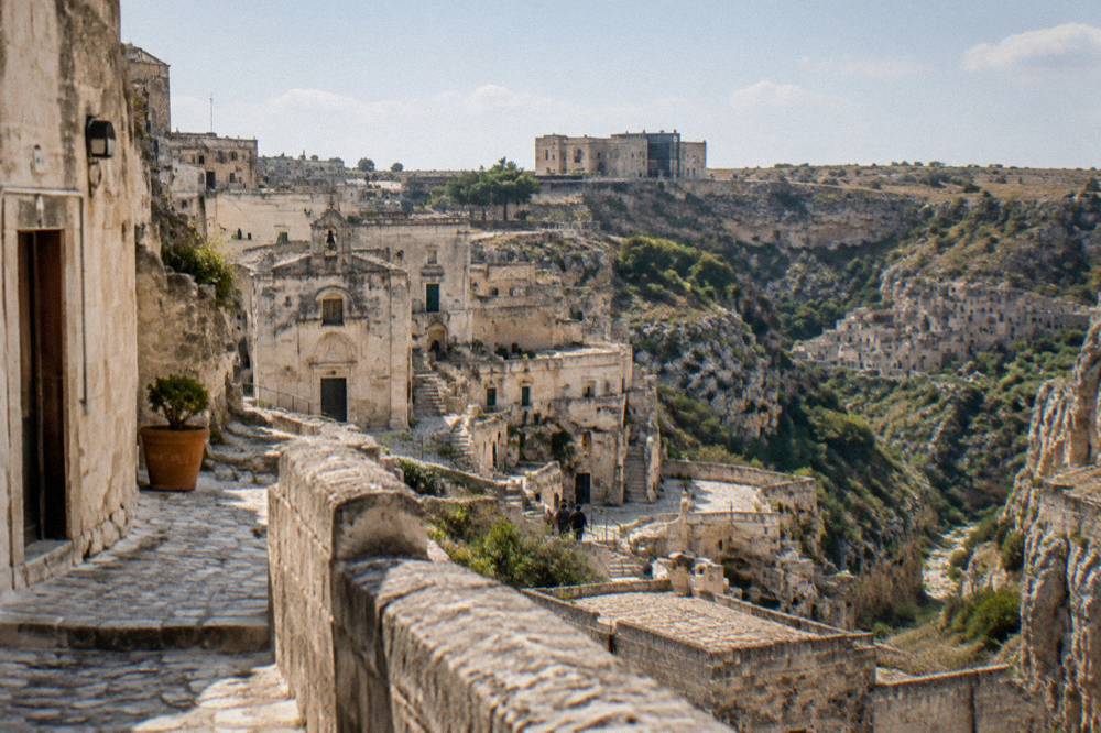 A stone visitor building on the plateau above the canyon at Matera