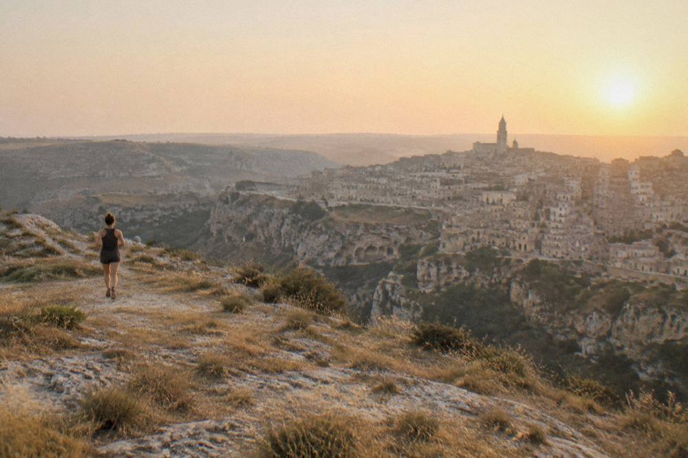 Panorama of the Sassi of Matera seen at sunset from the Murgia plateau across the gorge