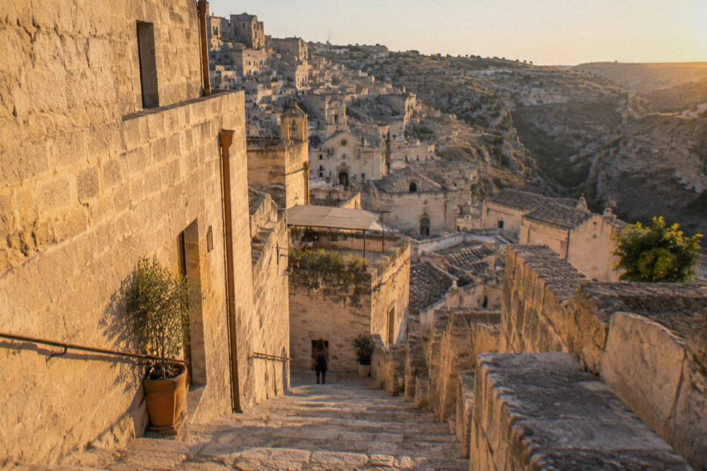 Stepped stone stairway descending between pale tufa buildings in Matera