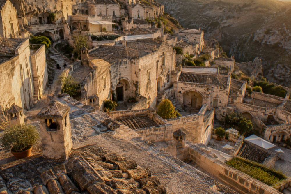 Terraced cave facades and chimneys of Sasso Barisano seen from a stone rooftop