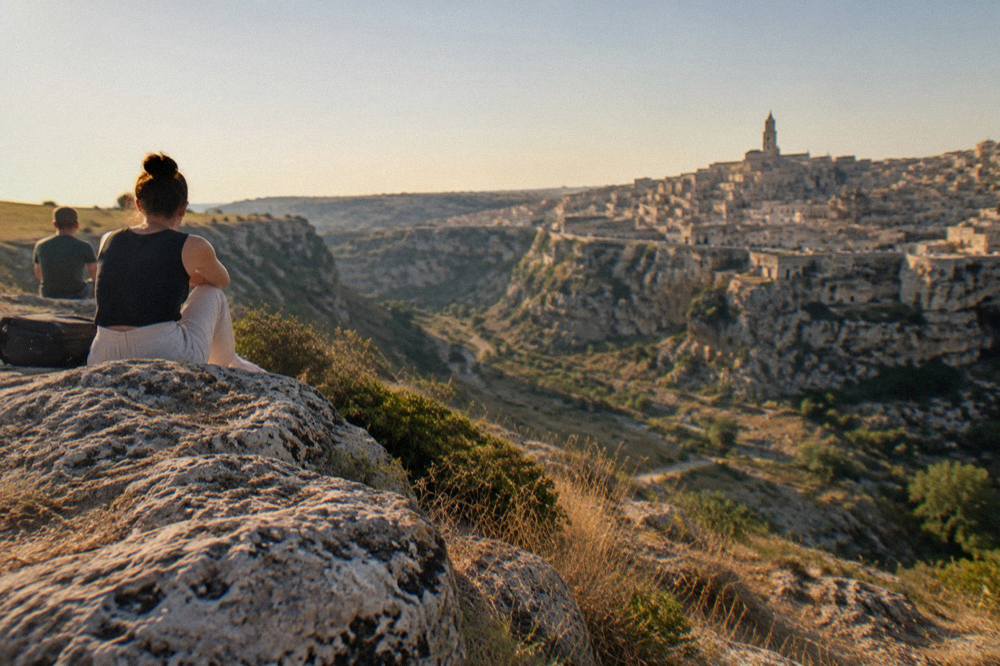 View across the Gravina canyon toward the terraced Sassi district at dusk