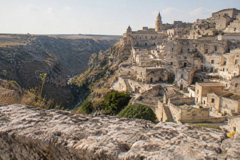 The Sassi districts seen from the Murgia plateau across the Gravina canyon in late afternoon