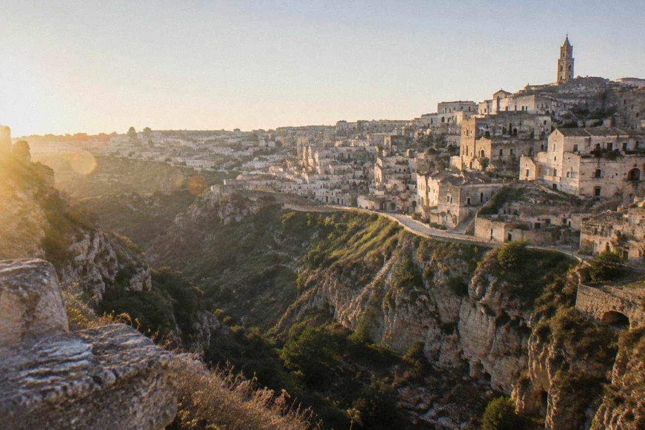 The Sassi of Matera seen from across the Gravina canyon in warm morning light