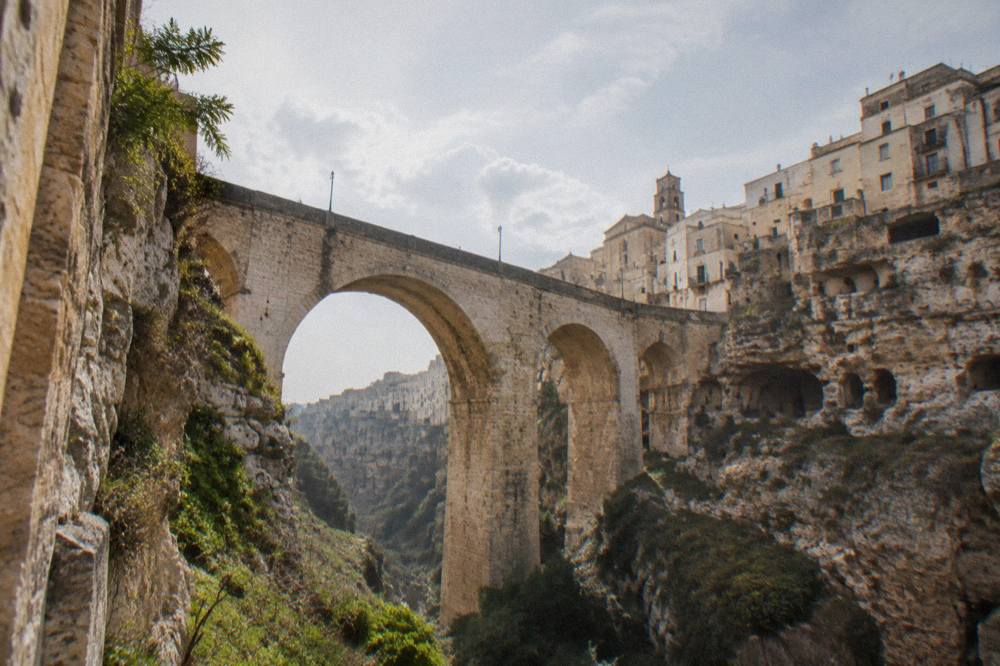 An old stone bridge spanning a deep limestone gorge