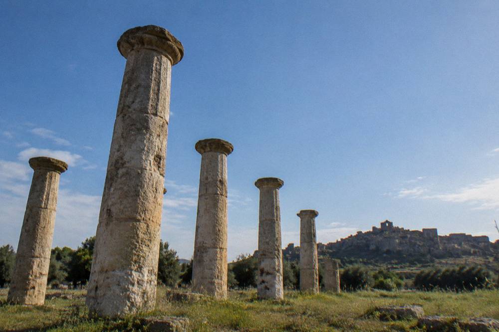 A ruined hill town of empty stone houses silhouetted on a ridge