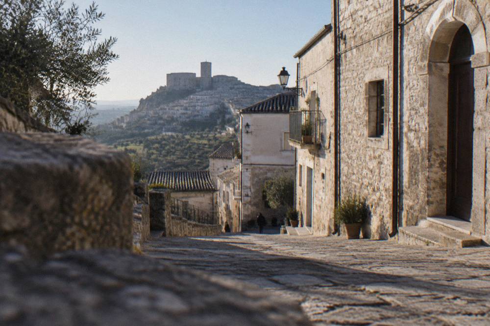 A narrow stone street in a small southern Italian hill town