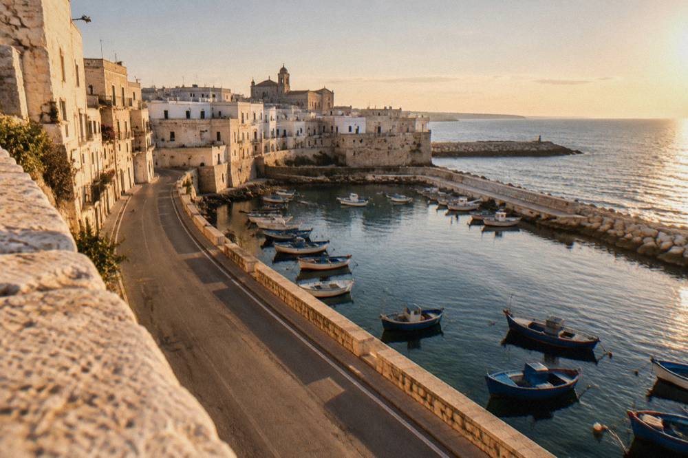 An empty coastal road winding along the Adriatic shoreline near Monopoli