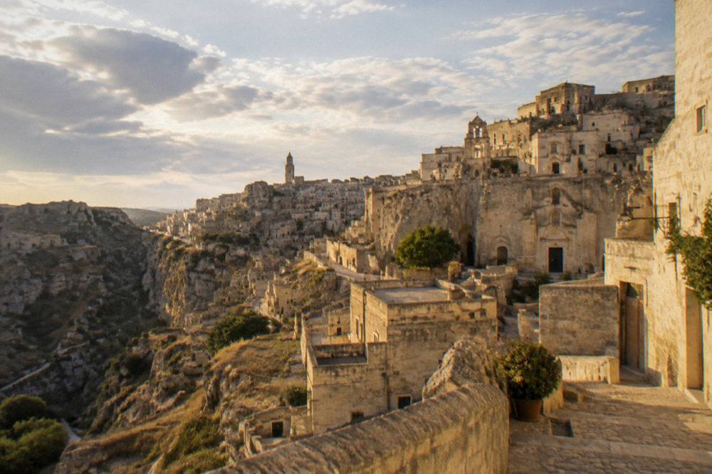 The Sassi cave dwellings of Matera glowing with warm light after sunset