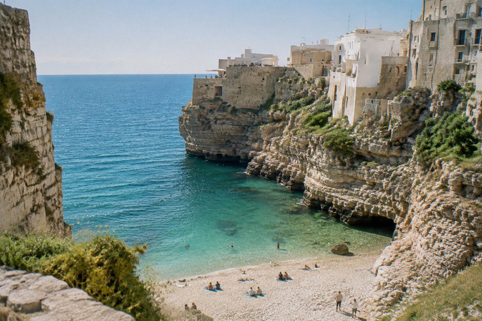 White cliffs above a small pebble cove on the Adriatic coast with turquoise water