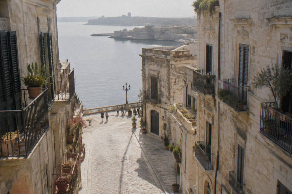 Narrow stone street in the old town island of Taranto with old buildings on both sides