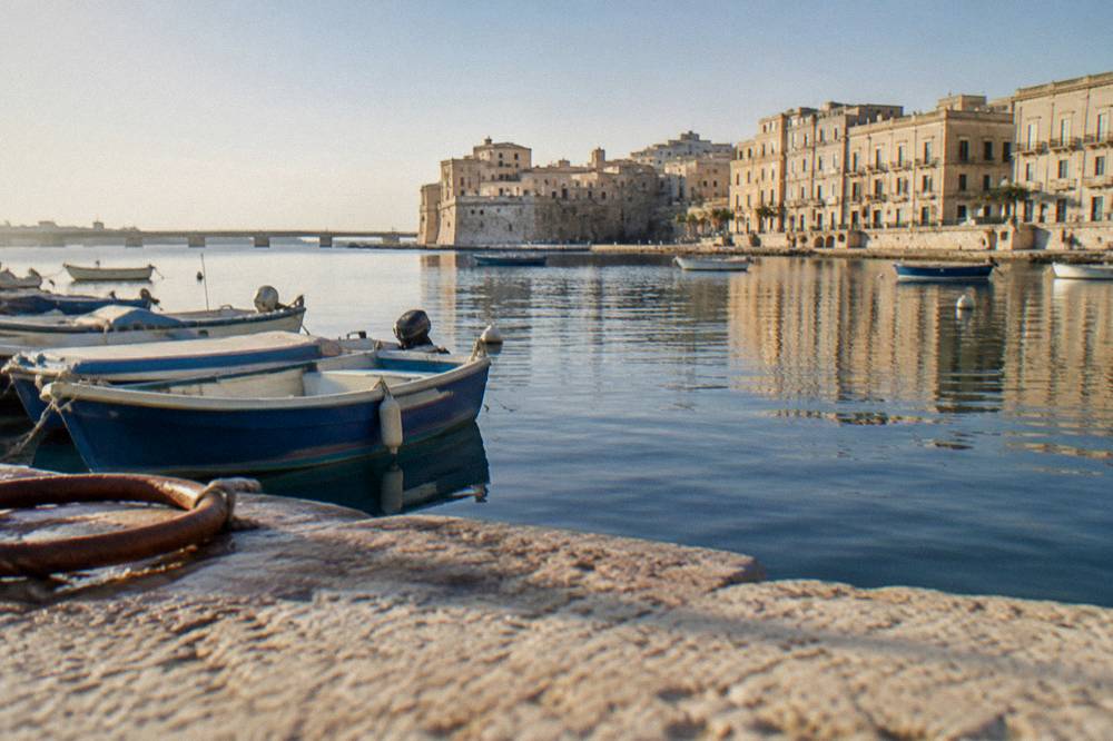 Sheltered inner water of Taranto with small boats and waterfront buildings