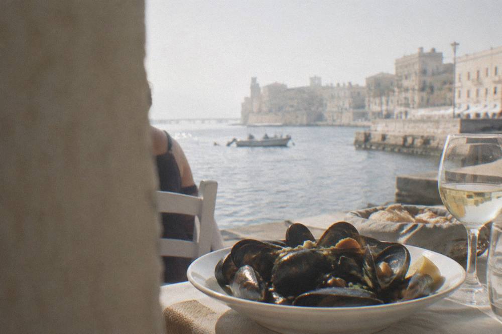 Plate of cooked mussels served on a table in a seaside restaurant