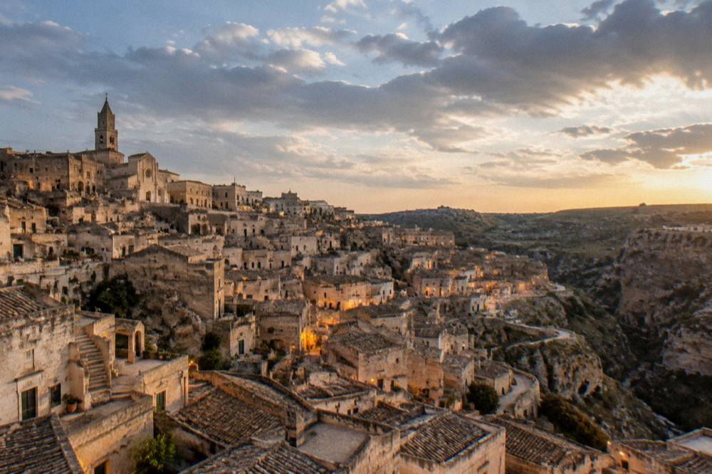 Evening view over the illuminated cave dwellings of the Sassi of Matera seen from above
