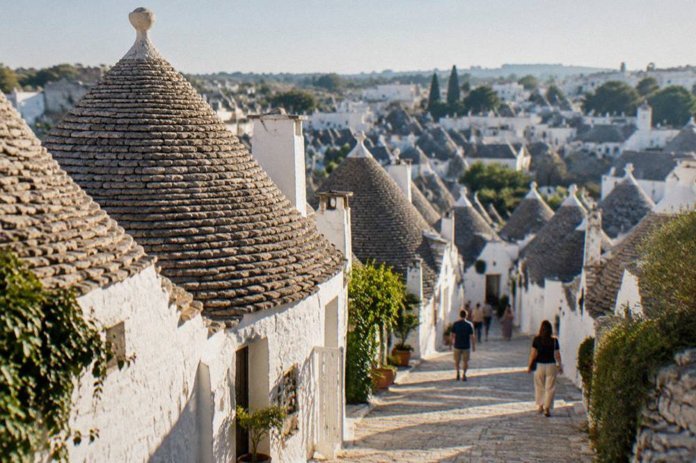 Rows of trulli houses with conical roofs seen from a viewpoint above the town