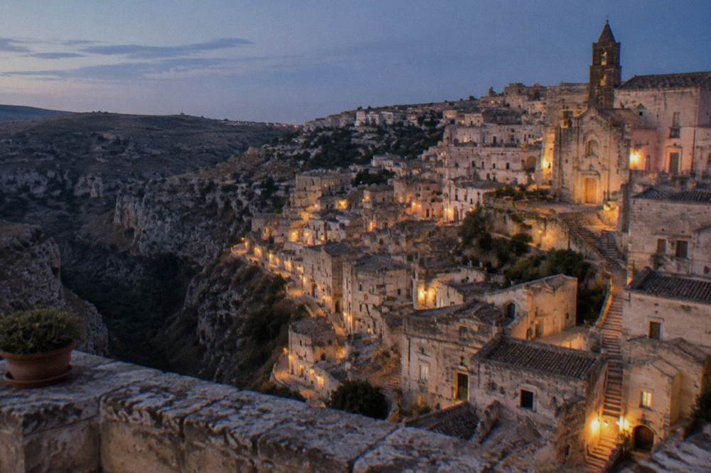 Evening lights of the Sassi seen from a terrace above the Gravina canyon