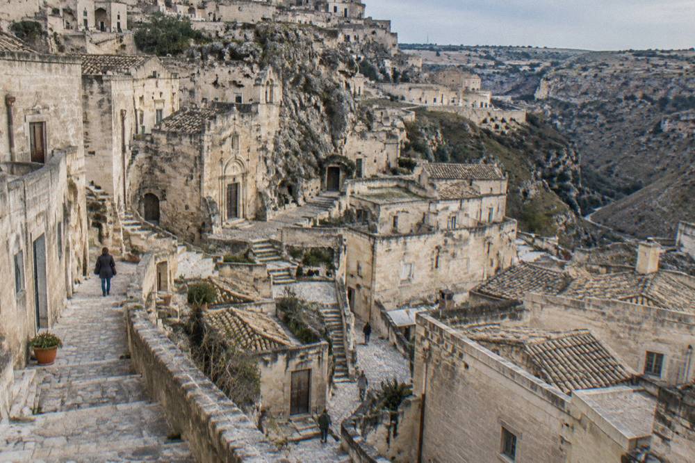 A street sign marking a limited traffic zone on a stone street in central Matera