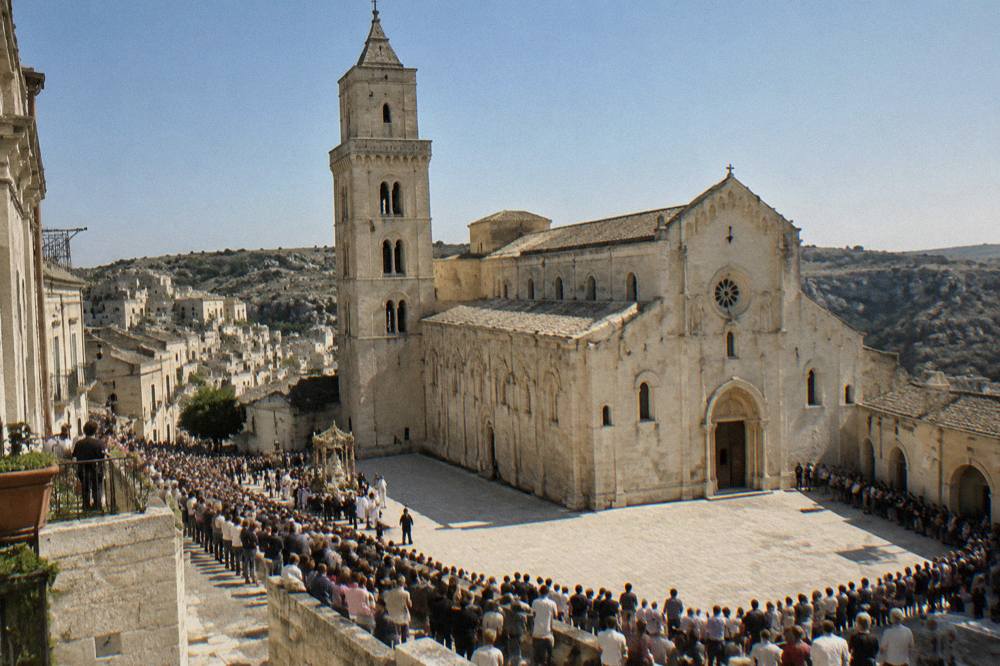 Crowds lining a stone street in a southern Italian town for a festival