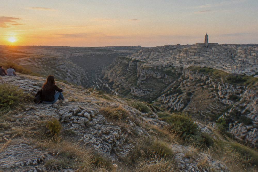A viewpoint over the Gravina canyon and the Sassi rooftops of Matera at golden hour