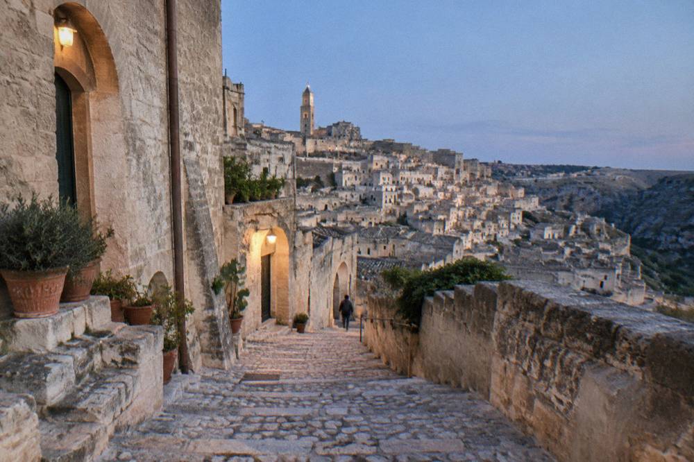 A narrow stepped lane between stone cave houses in the Sasso Barisano district