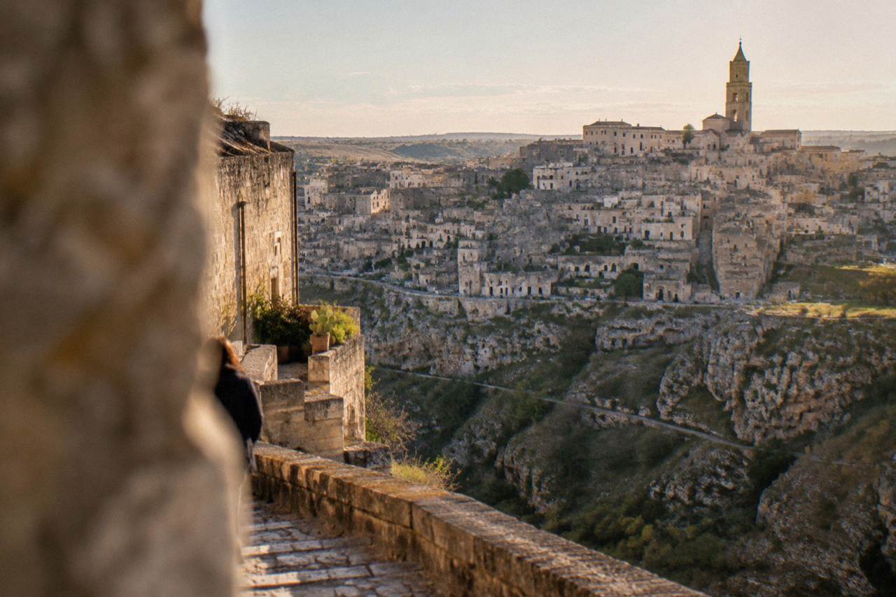 The Sassi district of Matera seen from across the Gravina canyon at golden hour