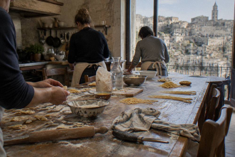A long table set for a pasta making class in a rustic farmhouse kitchen