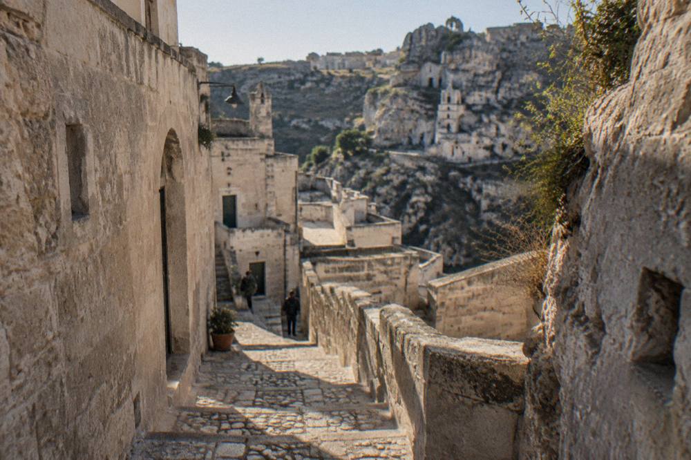 Narrow stone stairway between pale tufa buildings in the Sasso Caveoso district
