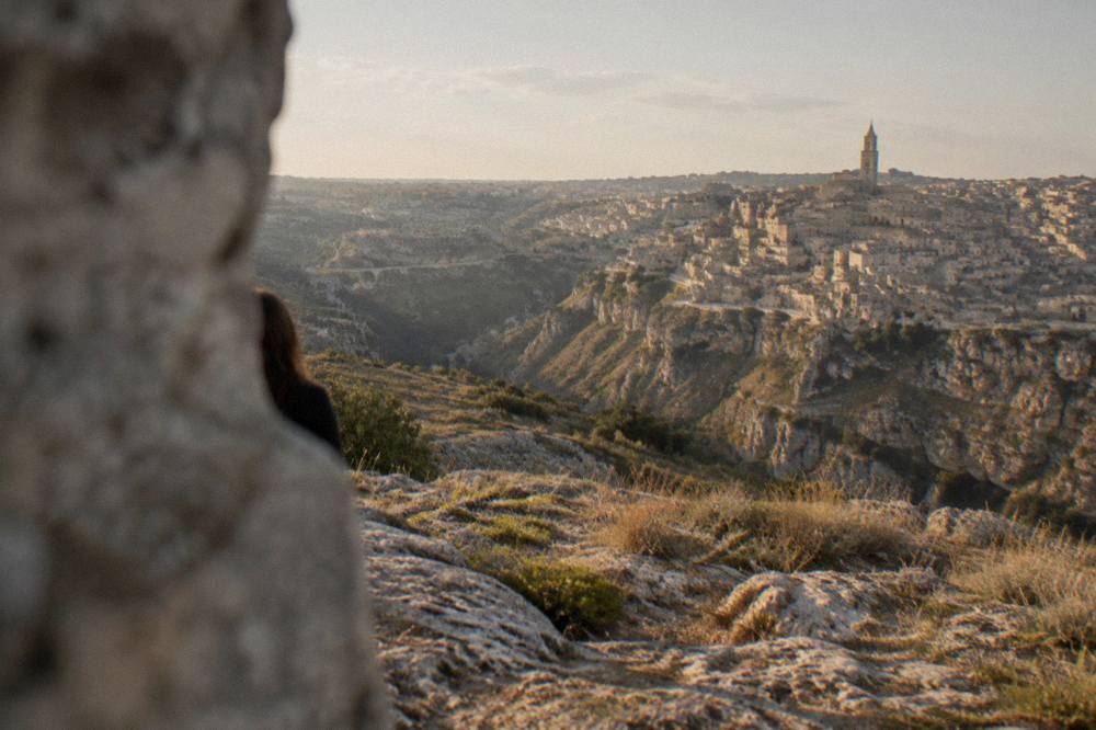 Panorama of the Sassi and the Gravina canyon seen from the Murgia plateau at golden hour