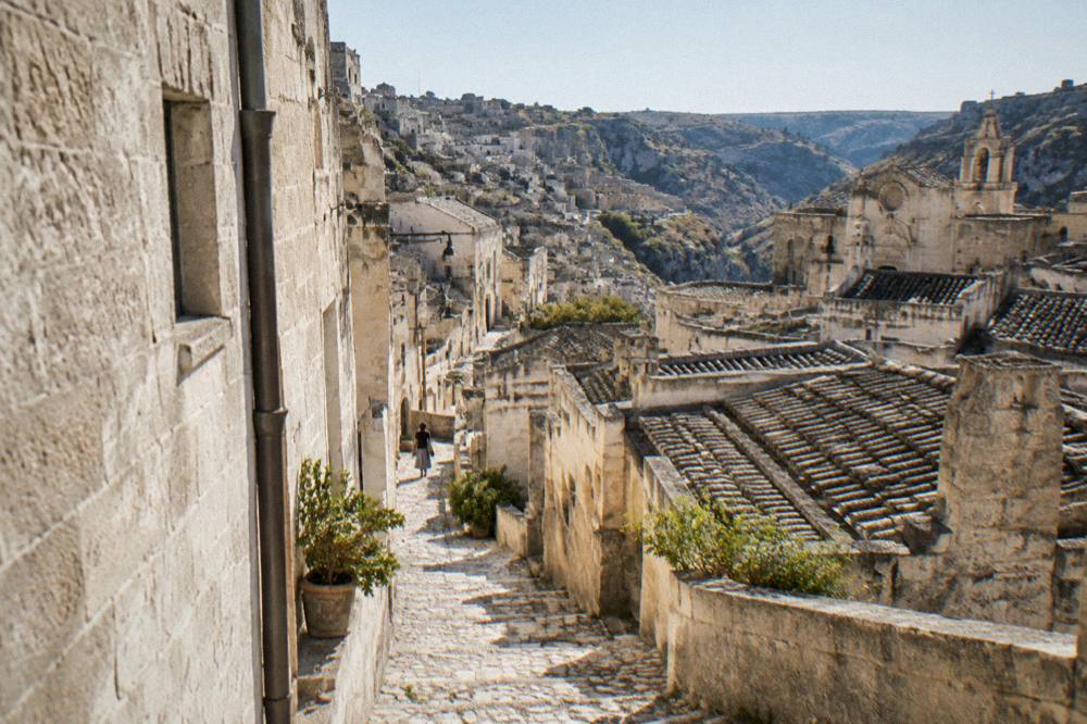 A narrow stepped lane between pale stone houses in the Sassi district of Matera